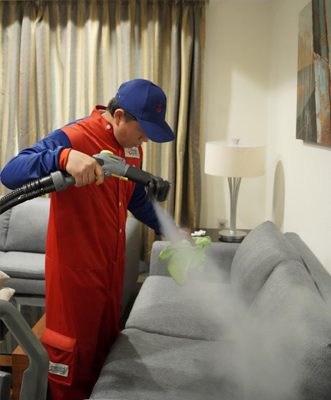 Sofa cleaner deep cleaning a fabric sofa in Doha, Qatar